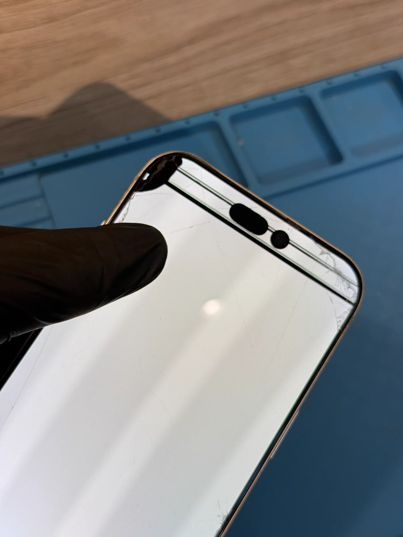 iPhone with a damaged front display before repair